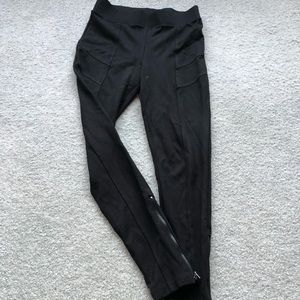 Black leggings with ankle zipper.